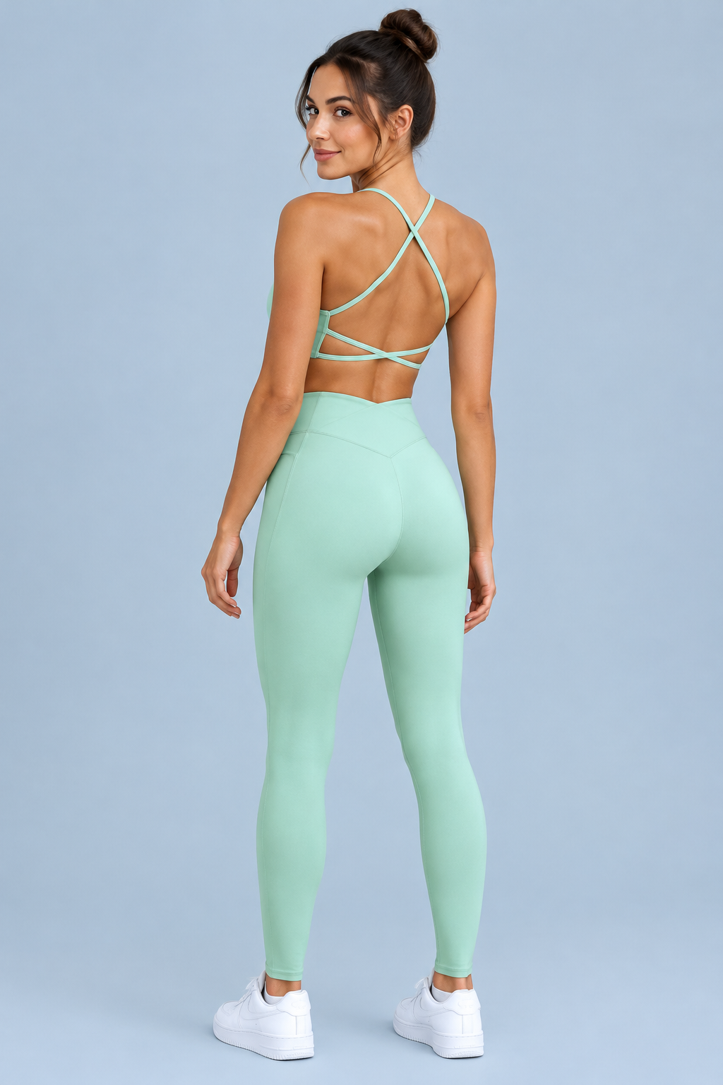 Over-the-shoulder view of the crisscross cami and matching leggings set